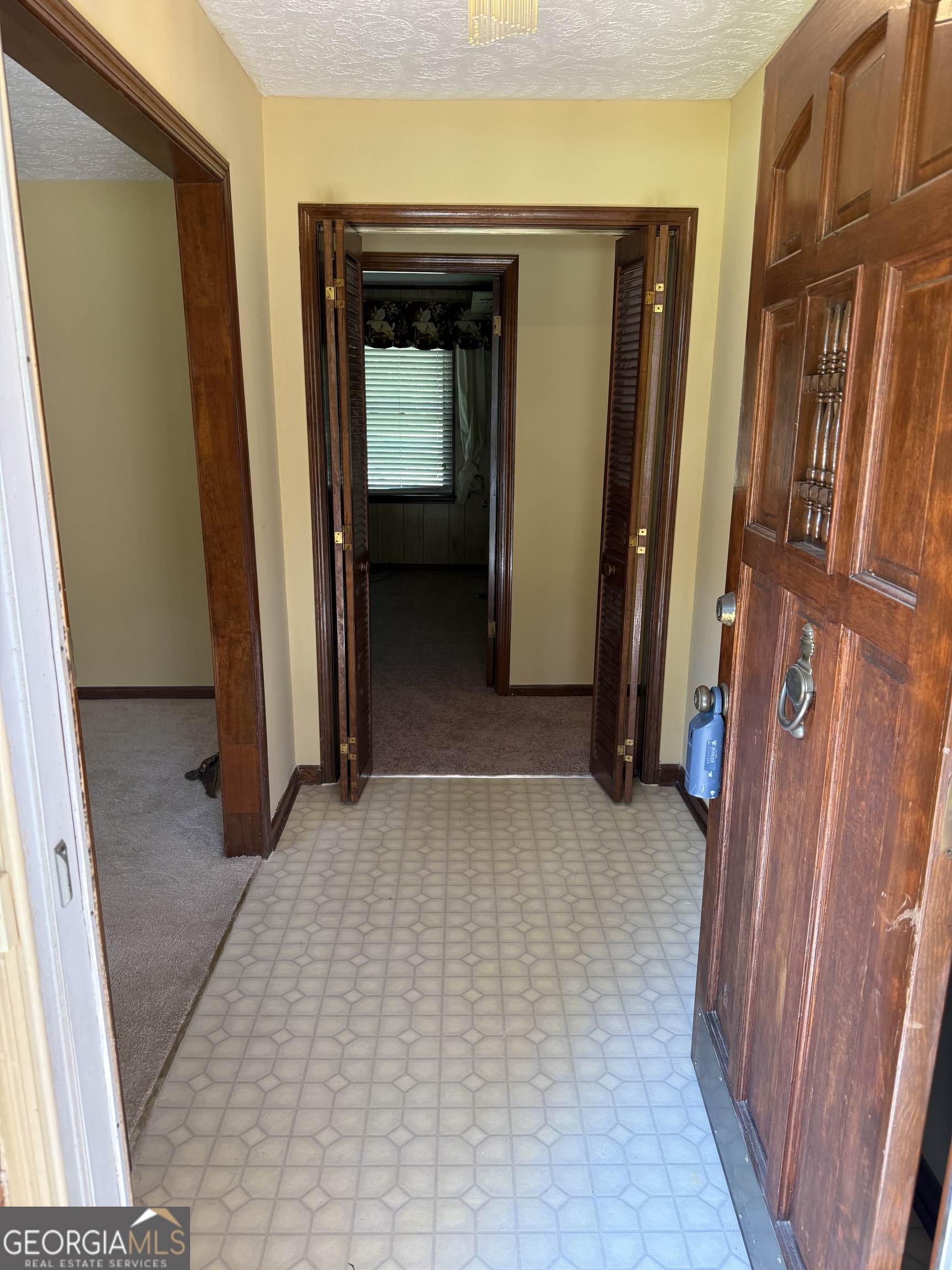 110 Otelia Lane Covington, GA 30014 - Photo 7 of 30 a view of a hallway with wooden walls and stairs