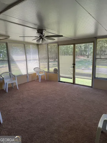 a view of a big room with windows and chandelier