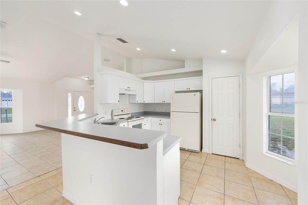 15434 Southwest 23rd Court Road Ocala, FL 34473 - Photo 17 of 41 a kitchen with kitchen island a sink appliances and cabinets