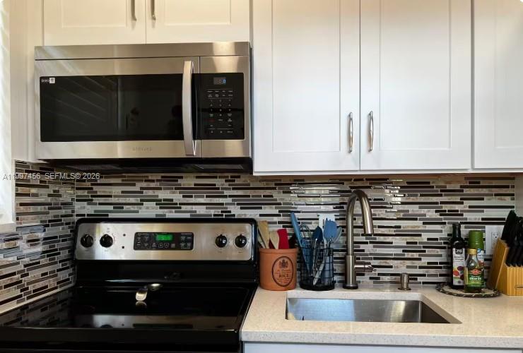 2160 Southwest 17th Street, Unit 2162 Miami, FL 33145 - Photo 11 of 28 a kitchen with stove and cabinets