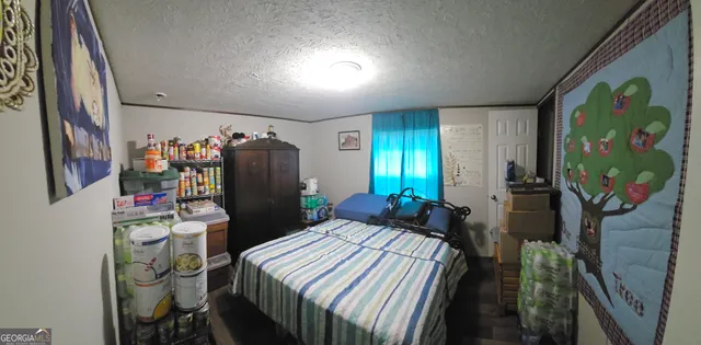 a bedroom with a bed and a mirror