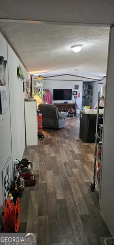 a spacious bedroom with a bed and wooden floor