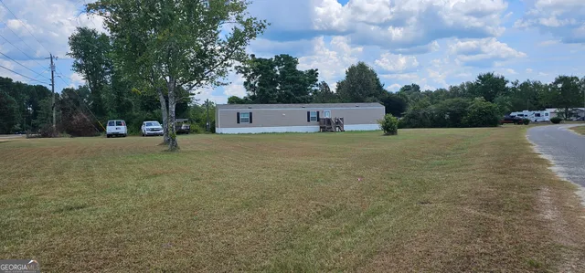 a backyard of a house with table and chairs