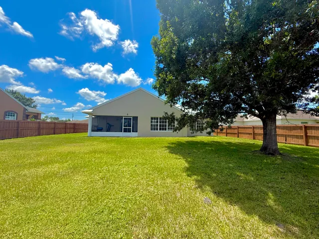 a view of a house with a backyard