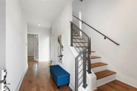a view of entryway and hall with wooden floor