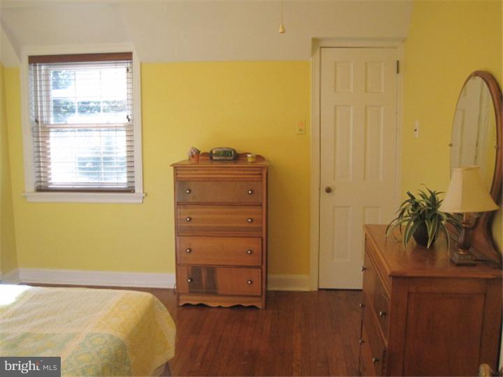 351 Mill Road Havertown, PA 19083 - Photo 17 of 24 a bedroom with a bed and wooden floor
