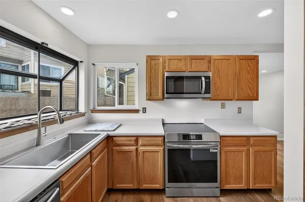 a kitchen with stainless steel appliances a stove sink and microwave