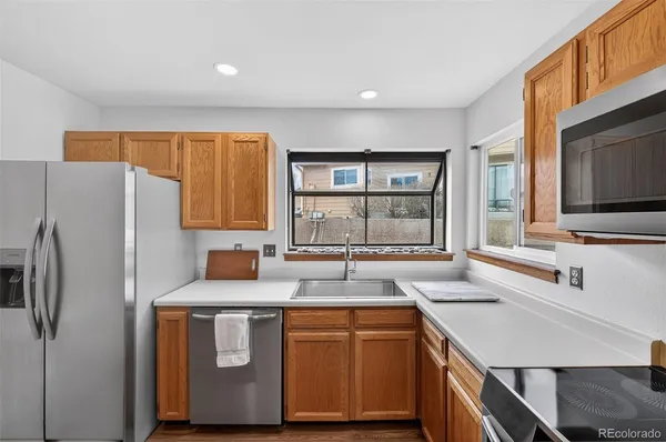 a kitchen with stainless steel appliances granite countertop a sink stove and refrigerator