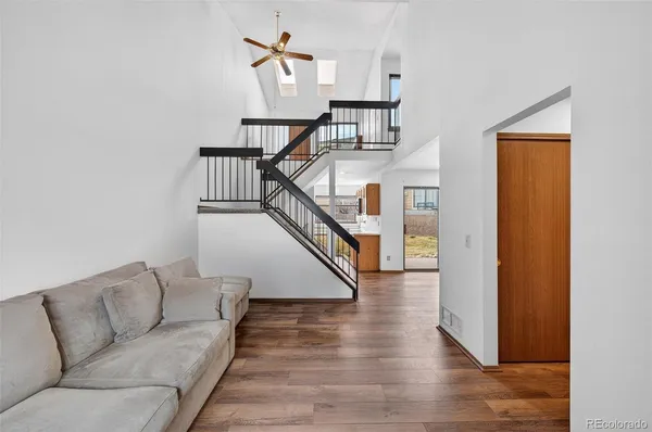a living room with furniture and stairs