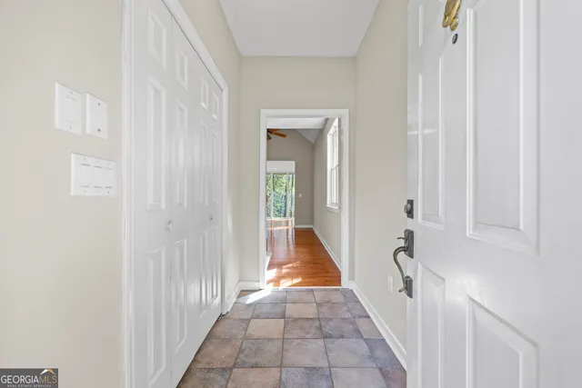 a view of empty room with wooden floor and fireplace