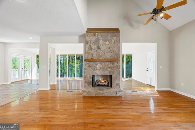a view of a room and balcony with a lake view