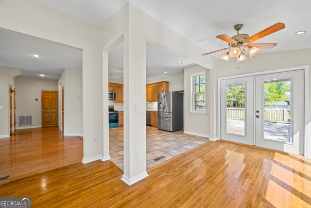 a view of a yard with plants and trees