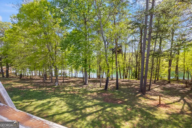 a kitchen with granite countertop stainless steel appliances cabinets a sink and a window