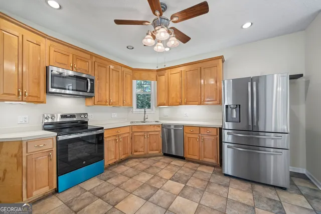 a view of an empty room with a fireplace and a large window