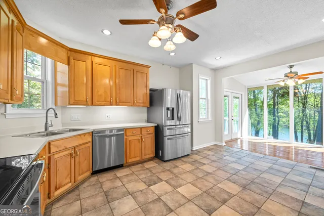 an empty room with window and ceiling fan