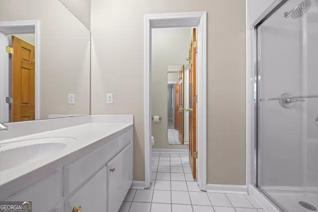 a white toilet sitting next to a white wall