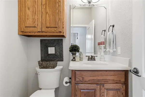 a bathroom with a sink a toilet and mirror