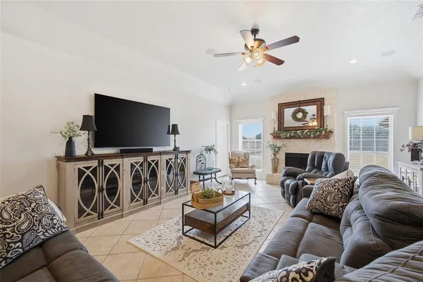 a living room with furniture flat screen tv and a fireplace