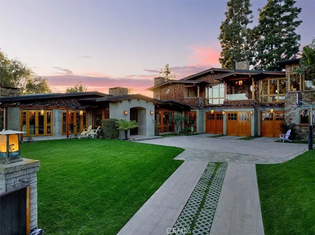 a front view of a house with a yard table and chairs