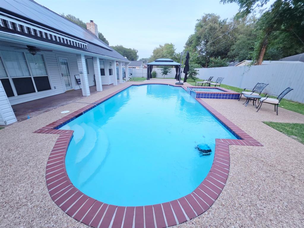 520 Red River Road Belton, TX 76513 - Photo 31 of 36 Expansive inground pool with brick coping, an integrated spa, and exposed aggregate decking