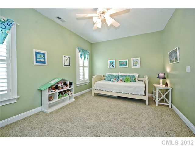 419 Bull Finch Bend Fort Mill, SC 29708 - Photo 11 of 16 a bedroom with a bed and a chandelier