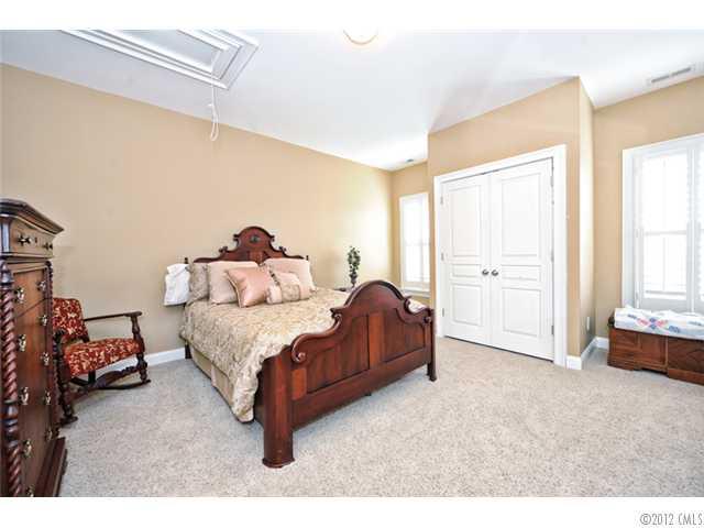 419 Bull Finch Bend Fort Mill, SC 29708 - Photo 12 of 16 a spacious bedroom with a bed and a window