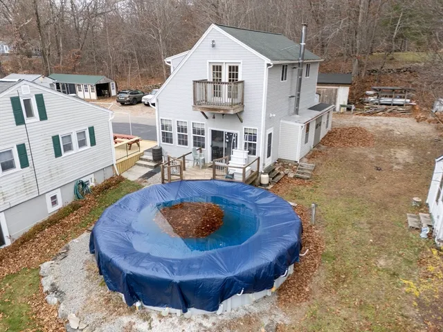 a view of a house with backyard and sitting area