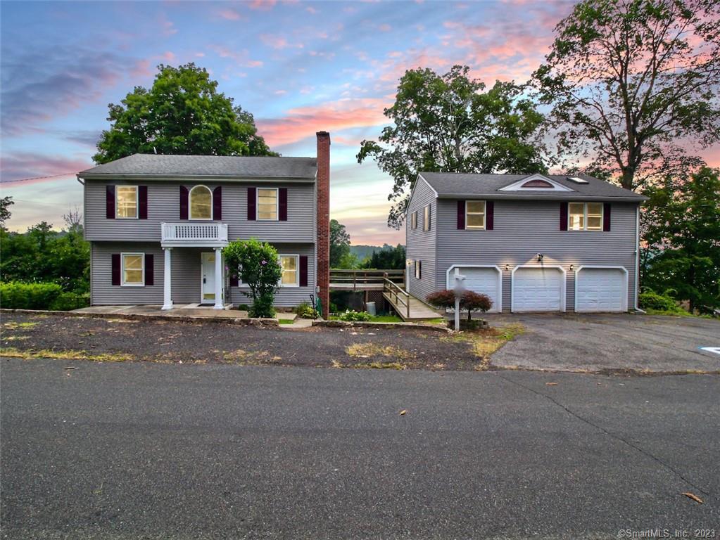 14 Massasoit Road Middlefield, CT 06455 - Photo 1 of 1 a front view of a house with a yard and a garage