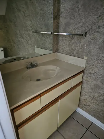 an empty room with a fireplace and windows