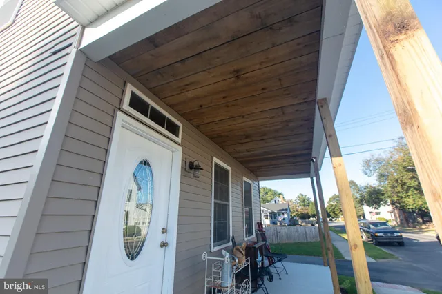 a view of a porch with chairs and a potted plant