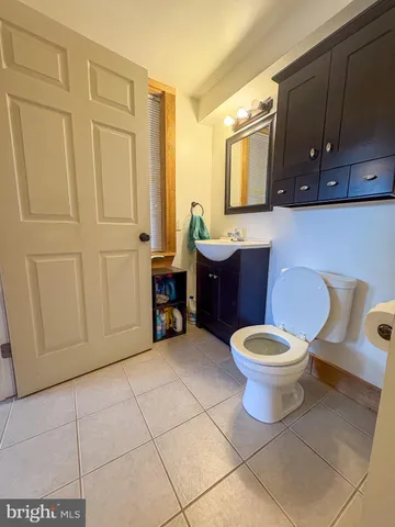 a kitchen with a sink a stove a refrigerator and wooden cabinets