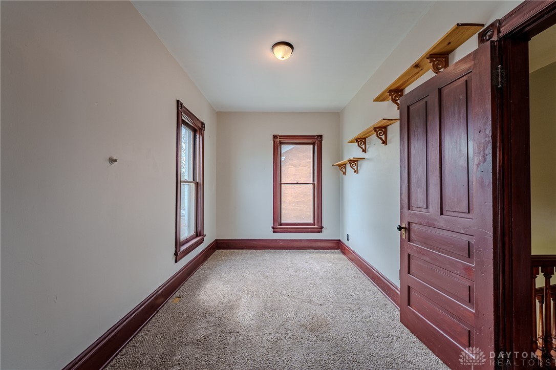 308 Yankee Road Middletown, OH 45044 - Photo 33 of 47 This cozy room features soft carpet flooring and classic wood-trimmed windows, perfect for quiet contemplation.