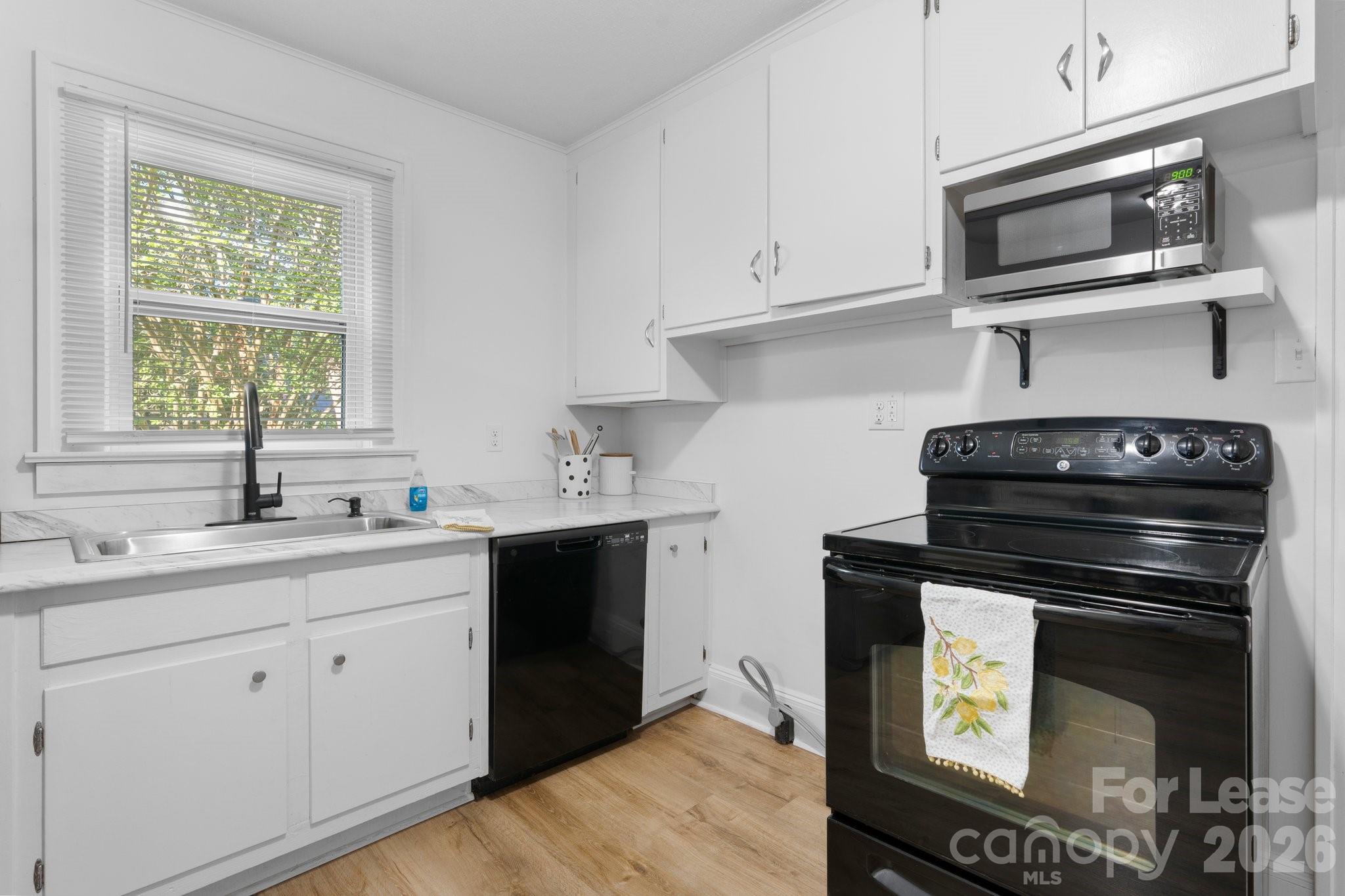 116 Barnes Lane Stony Point, NC 28678 - Photo 11 of 40 a kitchen with cabinets appliances a sink and a window