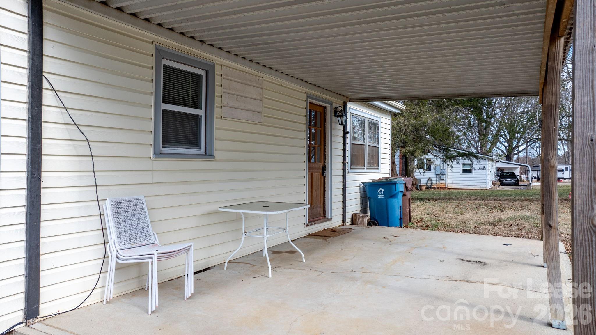 116 Barnes Lane Stony Point, NC 28678 - Photo 38 of 40 a view of a patio with table and chairs and wooden fence