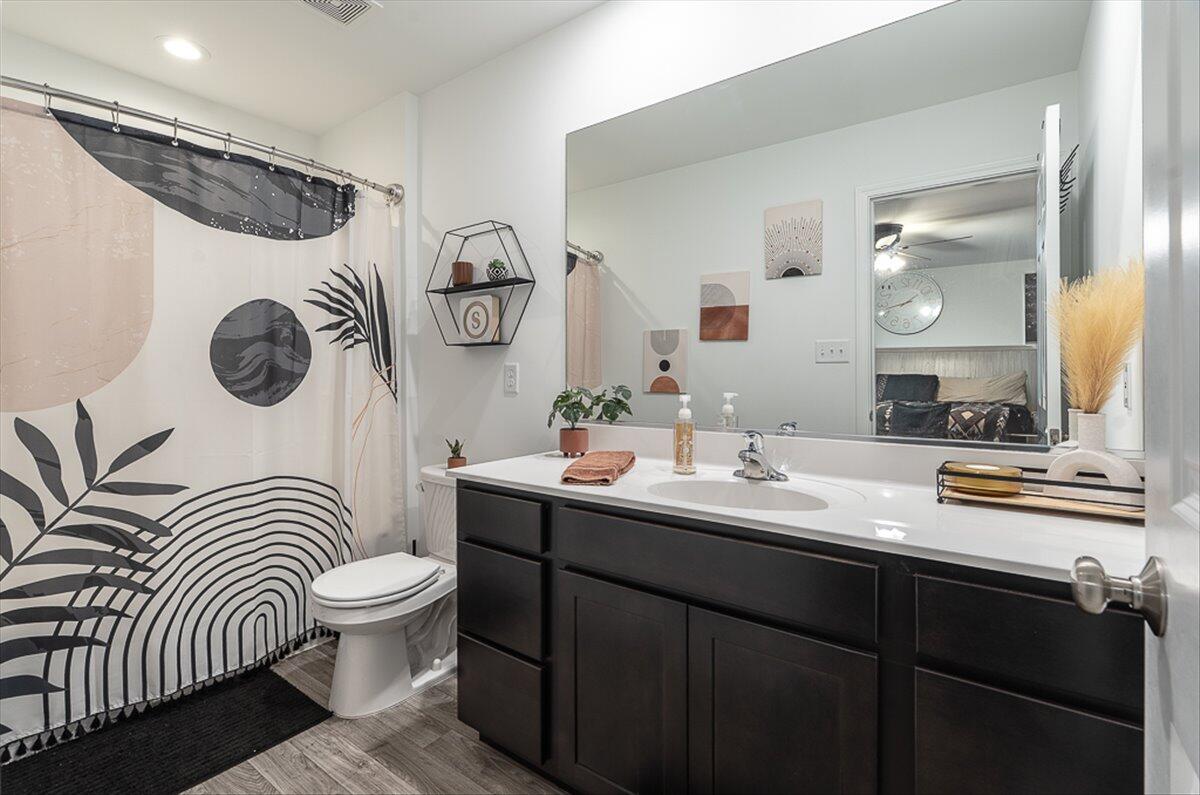 10377 Nevada Place Crown Point, IN 46307 - Photo 13 of 21 a bathroom with a sink a mirror a toilet and vanity