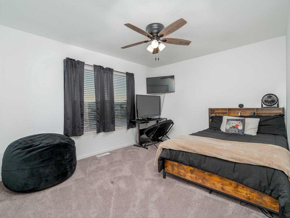 10377 Nevada Place Crown Point, IN 46307 - Photo 14 of 21 a bedroom with a bed and a chandelier