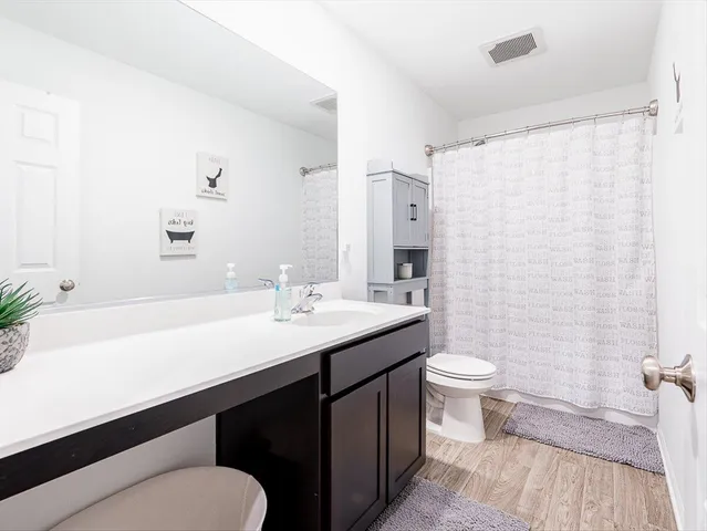 a bedroom with bed and a chandelier