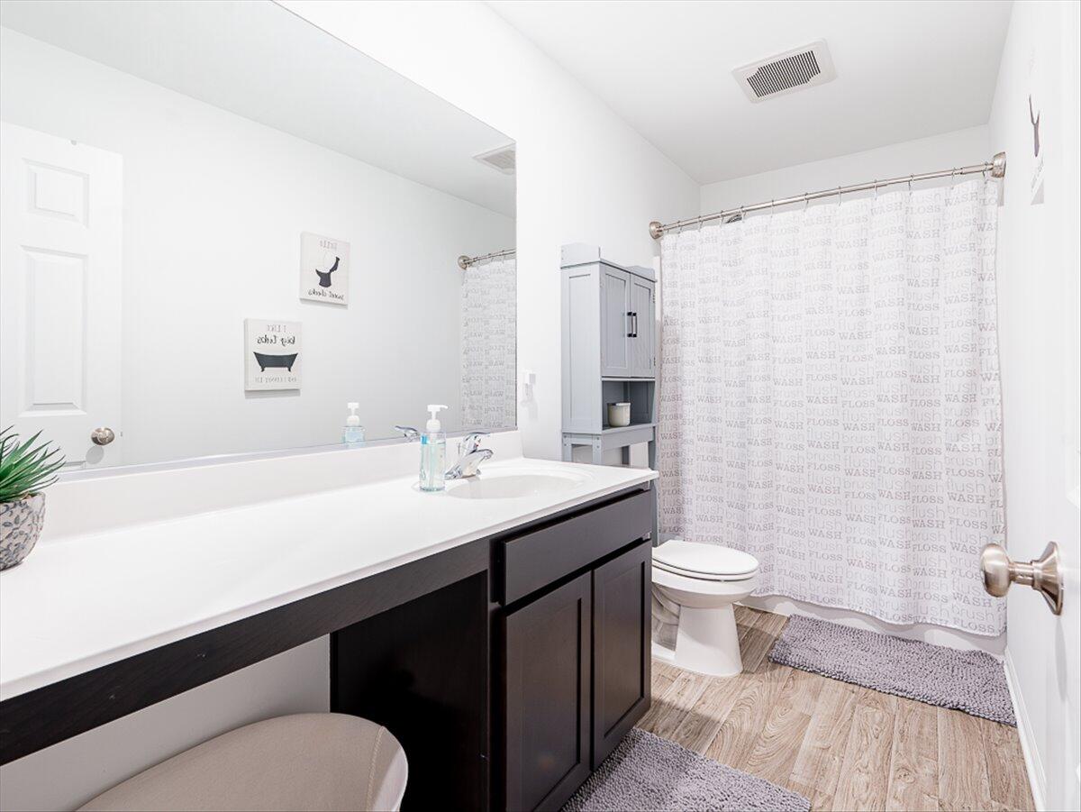 10377 Nevada Place Crown Point, IN 46307 - Photo 16 of 21 a bathroom with a sink a toilet a mirror and shower