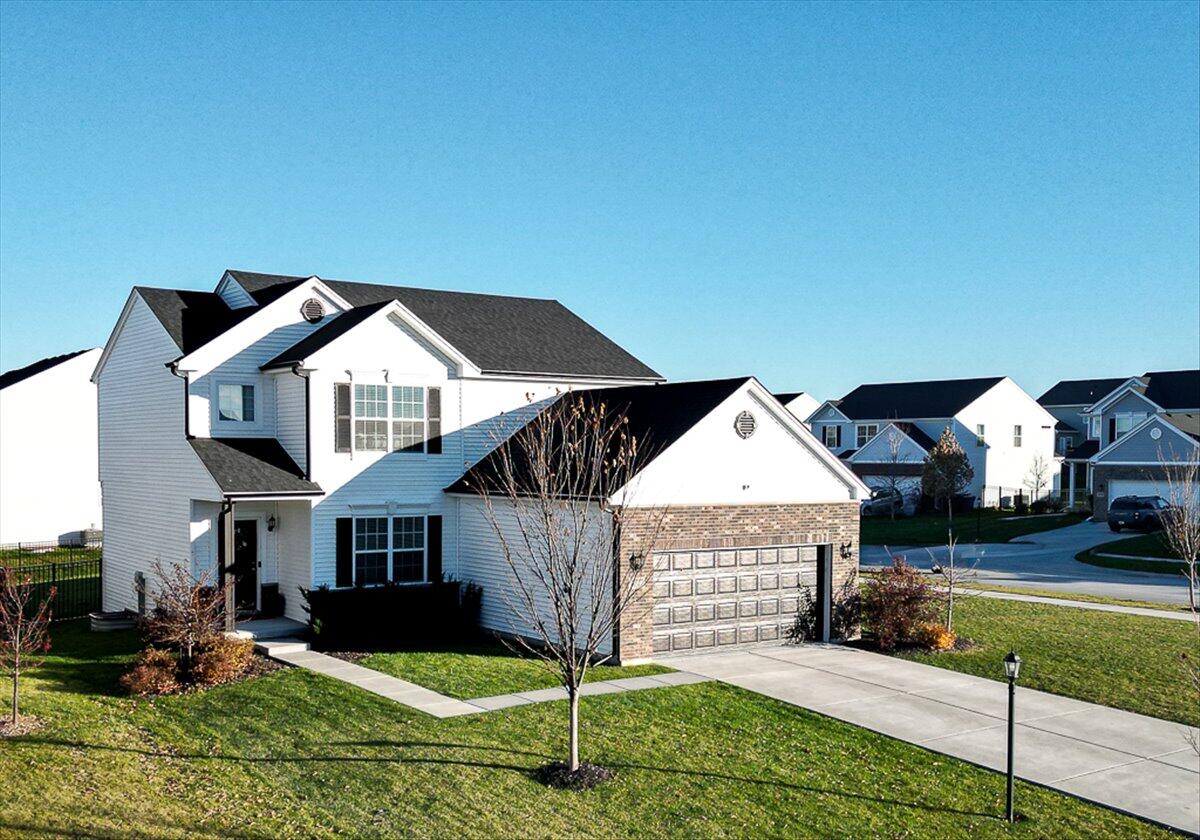 10377 Nevada Place Crown Point, IN 46307 - Photo 3 of 21 a front view of a house with a yard