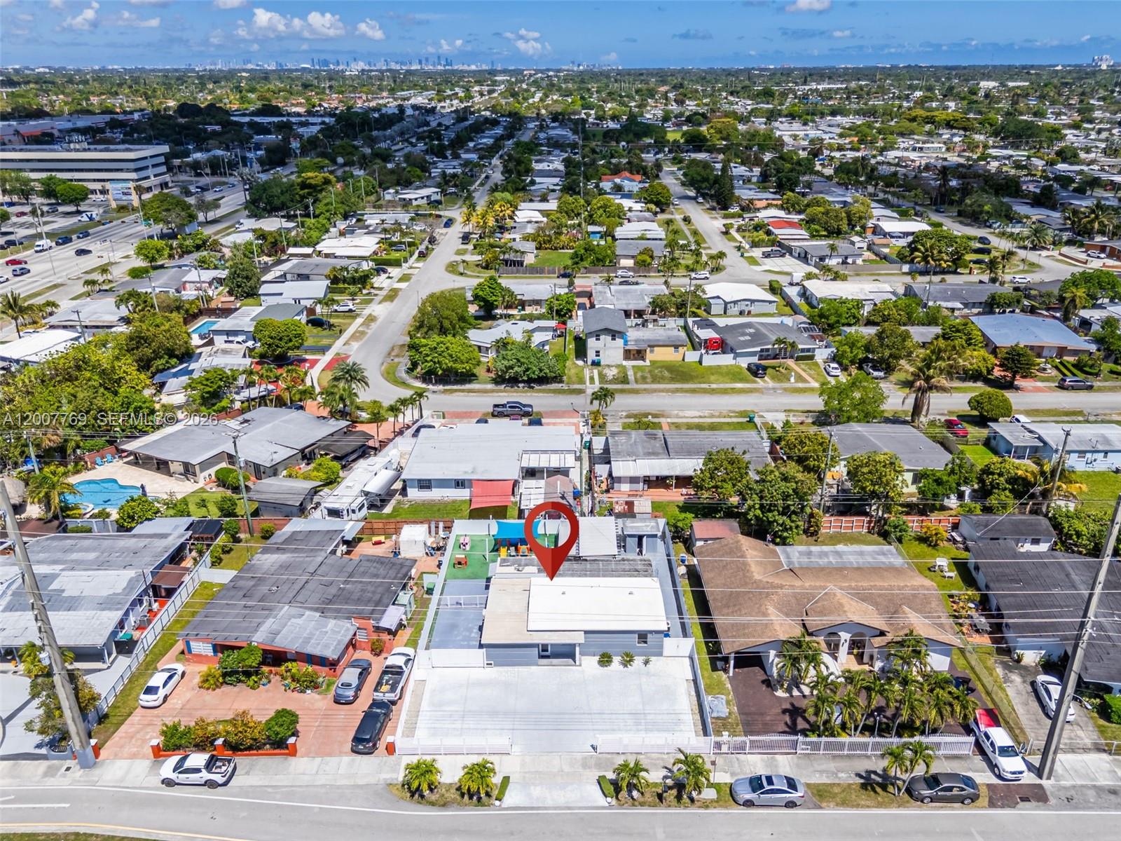 4041 Southwest 117th Avenue Miami, FL 33175 - Photo 16 of 47 an aerial view of a city with lots of residential buildings and mountain view in back