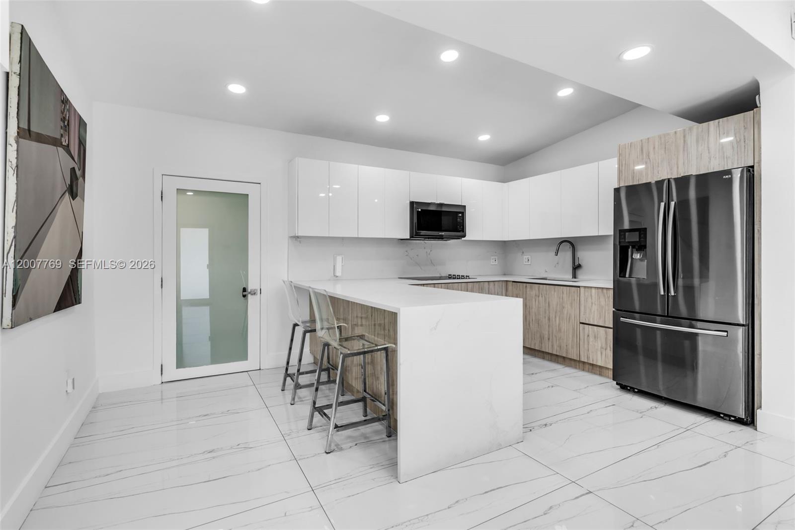 4041 Southwest 117th Avenue Miami, FL 33175 - Photo 31 of 47 a kitchen with stainless steel appliances granite countertop a refrigerator and a stove top oven