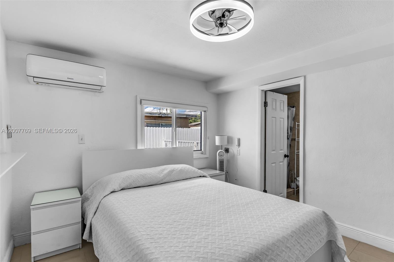 4041 Southwest 117th Avenue Miami, FL 33175 - Photo 43 of 47 a bedroom with a bed and a chandelier