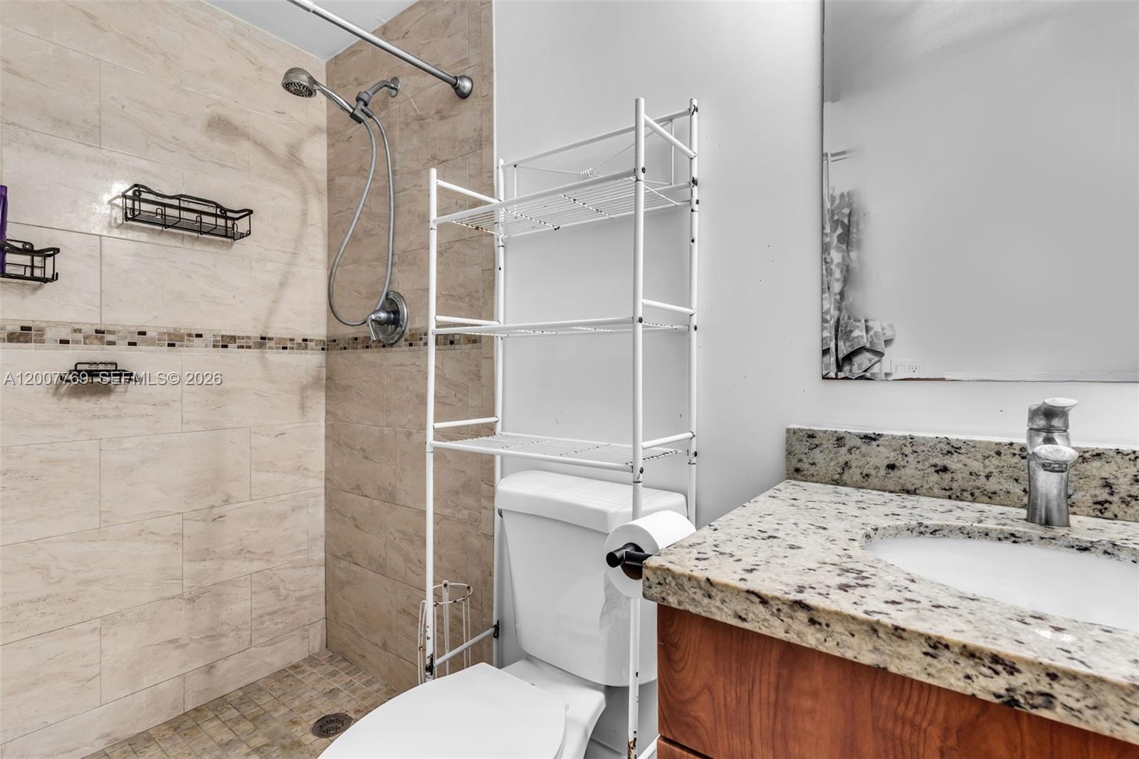 4041 Southwest 117th Avenue Miami, FL 33175 - Photo 44 of 47 a bathroom with a granite countertop sink a toilet and shower
