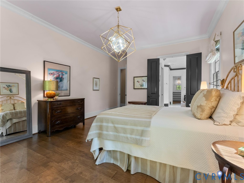 16131 Binley Road Midlothian, VA 23112 - Photo 44 of 99 a bedroom with a bed and a chandelier