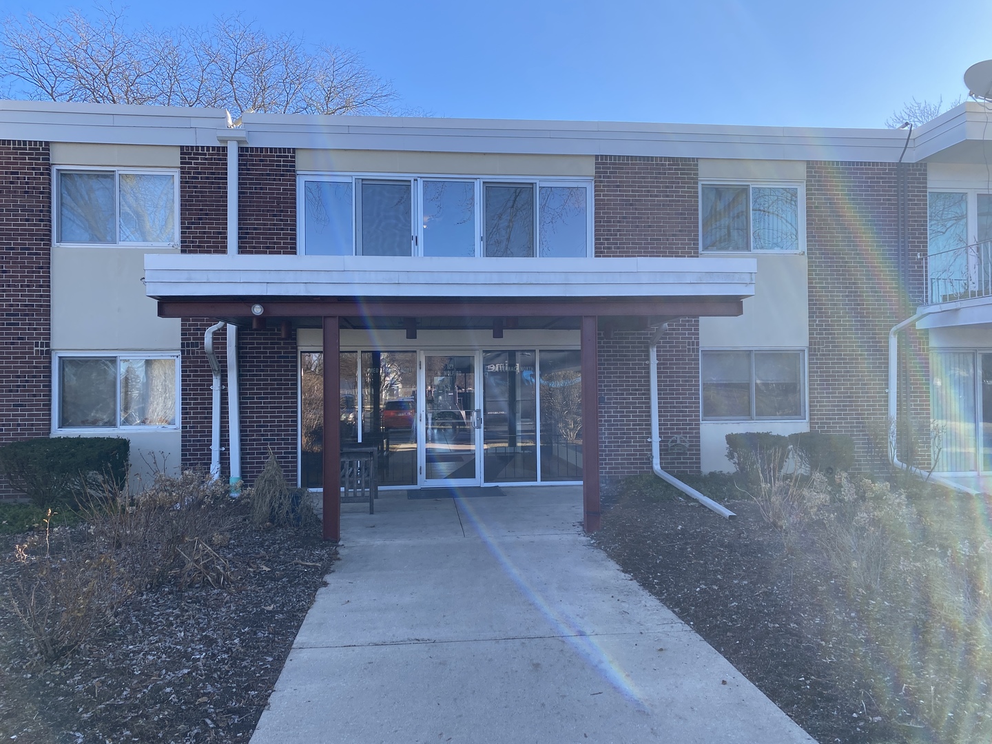 127 North Wolf Road, Unit 56A Wheeling, IL 60090 - Photo 1 of 13 front view of a brick house with a yard