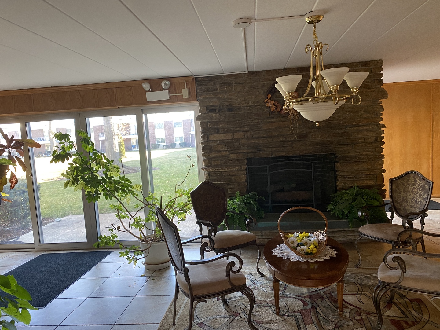 127 North Wolf Road, Unit 56A Wheeling, IL 60090 - Photo 2 of 13 a living room with furniture and a fireplace