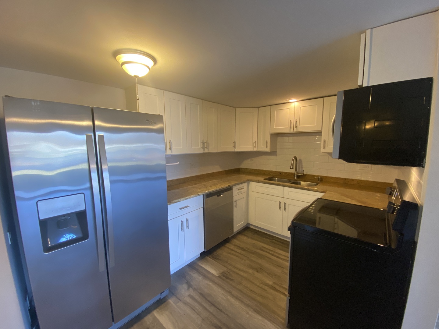 127 North Wolf Road, Unit 56A Wheeling, IL 60090 - Photo 5 of 13 a kitchen with a refrigerator and a sink