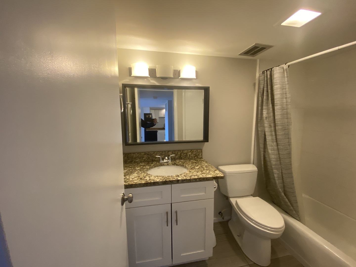 127 North Wolf Road, Unit 56A Wheeling, IL 60090 - Photo 8 of 13 a bathroom with a granite countertop sink toilet and mirror