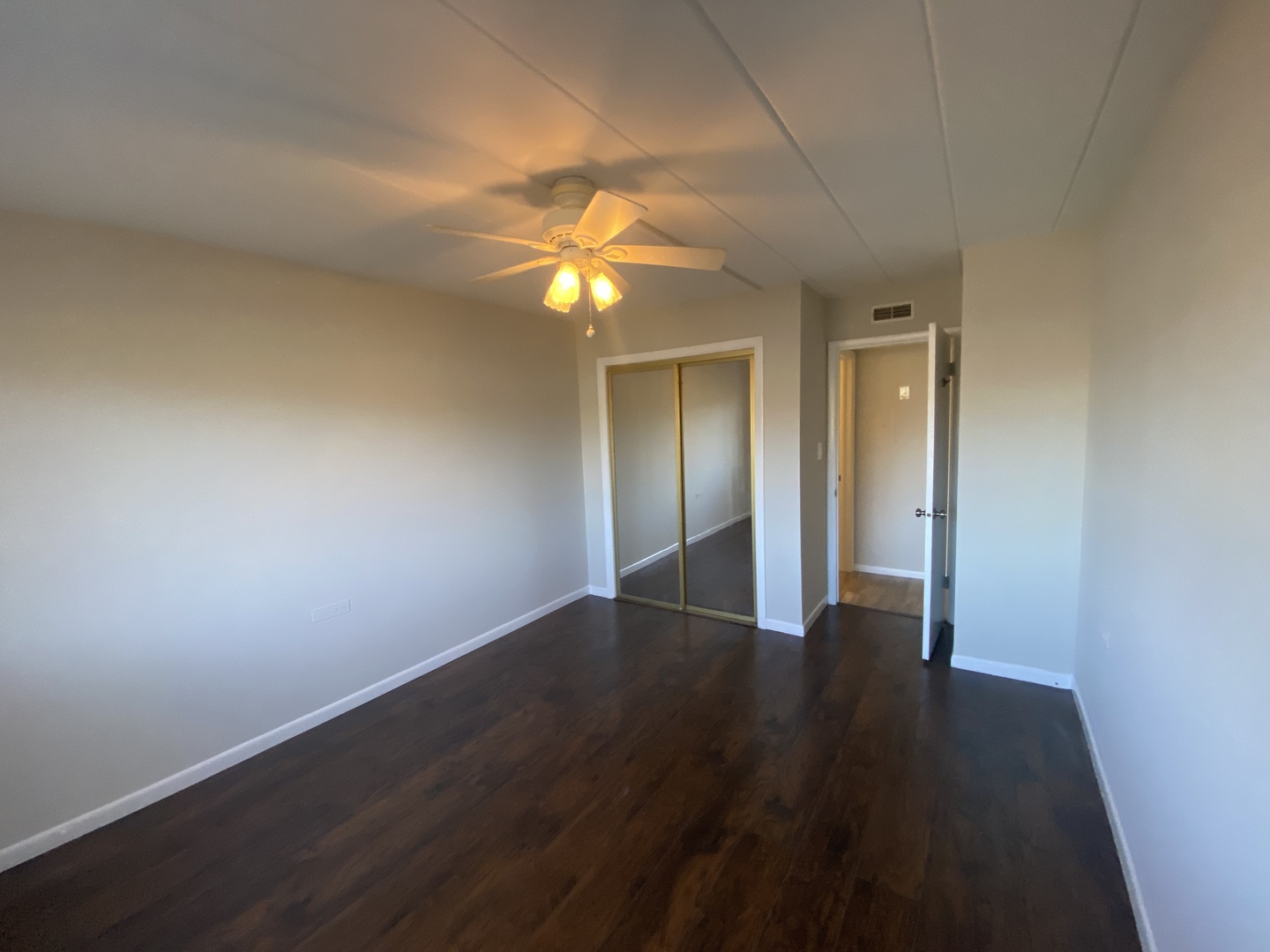 127 North Wolf Road, Unit 56A Wheeling, IL 60090 - Photo 9 of 13 a view of an empty room with wooden floor