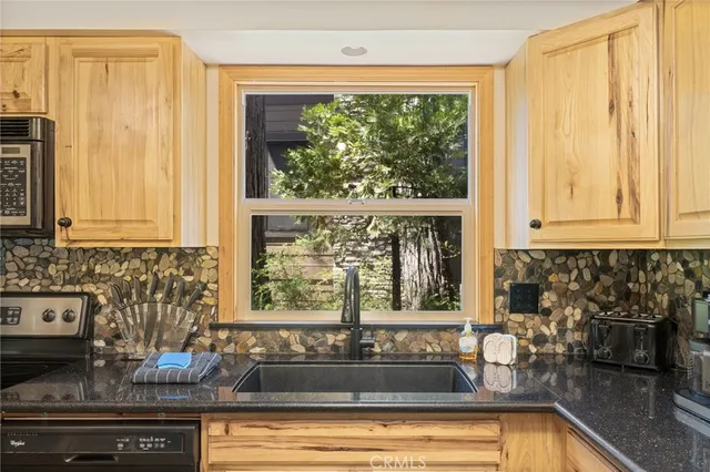 a view of a kitchen with a sink and large window
